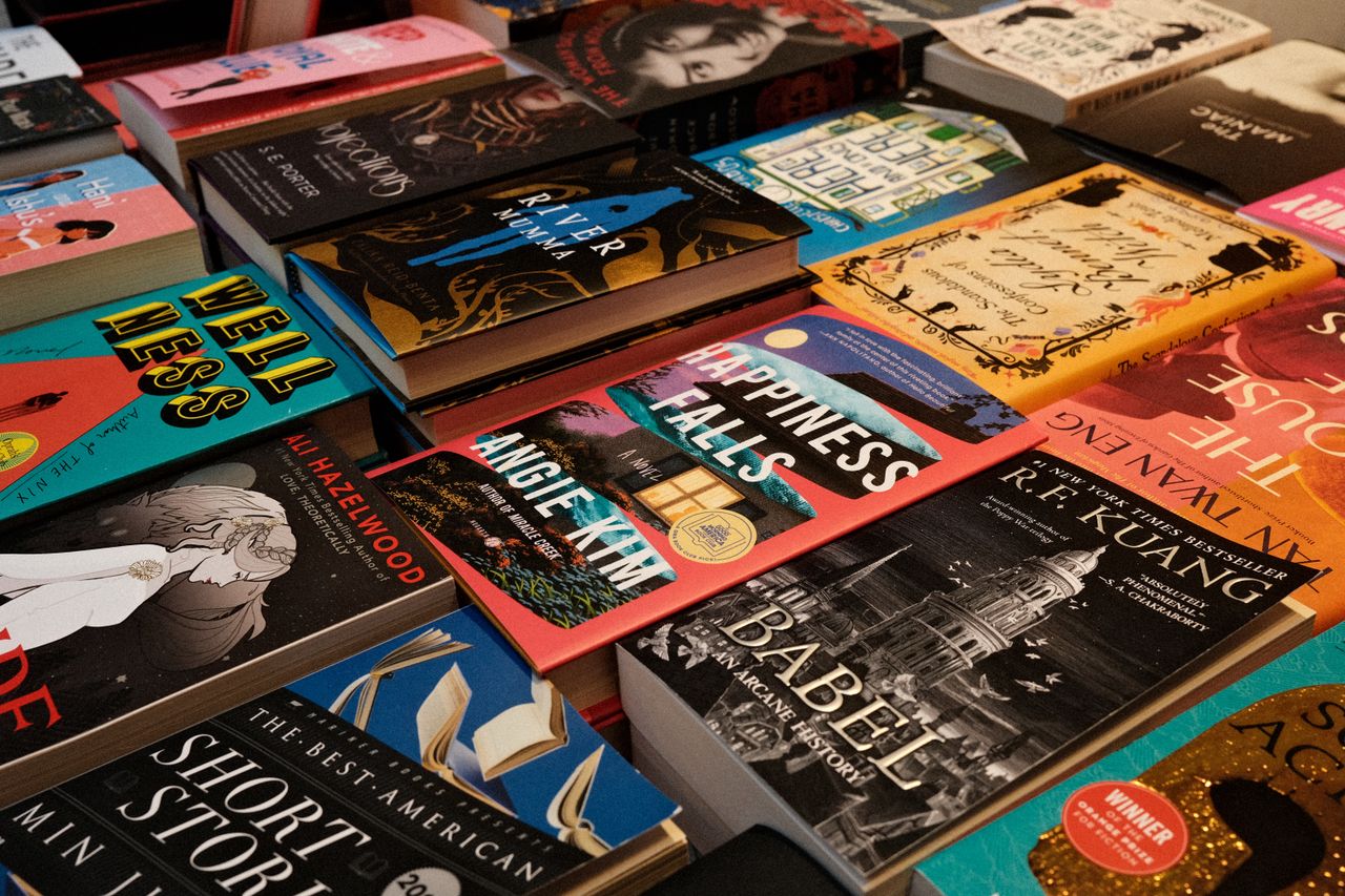 Diverse collection of bestsellers displayed at a New York bookstore, featuring colorful covers and popular titles.